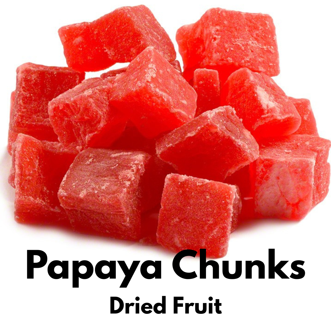 Bright red dried papaya chunks piled together, showing their soft, chewy texture against a white background.